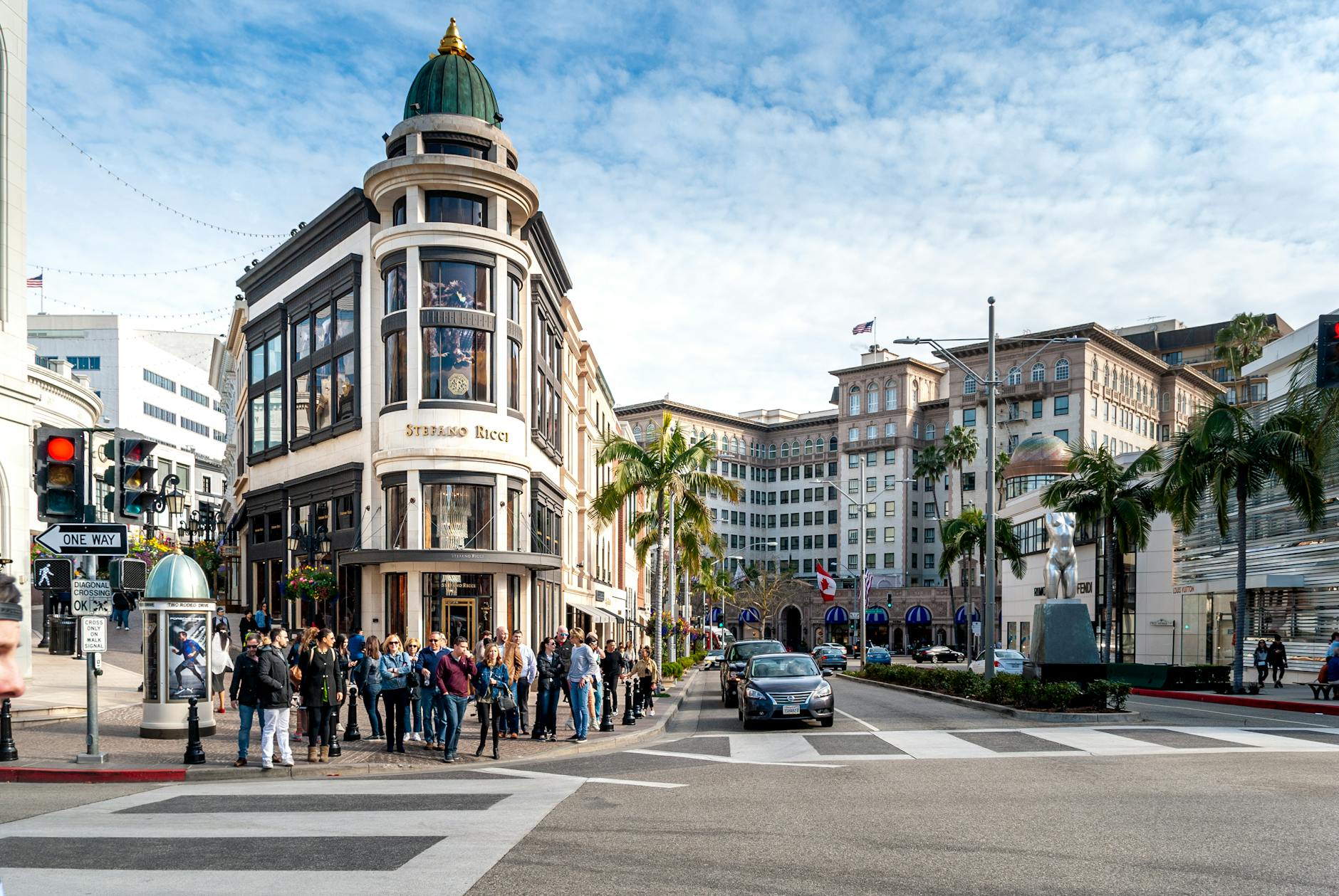 A scenic view of a palm-lined avenue in Beverly Hills, California, showcasing the iconic local residential architecture.